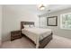 Bright bedroom featuring natural light, a stylish bed, and neutral-toned carpet for a cozy feel at 410 Glenmont Ct, Atlanta, GA 30350
