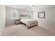 Bedroom featuring a simple bed, neutral carpet, and a cozy, minimalist ambiance at 410 Glenmont Ct, Atlanta, GA 30350