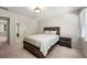 Bedroom featuring carpet, a bed, and a view into the connected bathroom at 410 Glenmont Ct, Atlanta, GA 30350