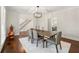 Classic dining room showcasing hardwood floors, a rustic chandelier, and access to staircase at 410 Glenmont Ct, Atlanta, GA 30350