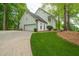 Exterior view of the white house featuring an attached garage and manicured lawn at 410 Glenmont Ct, Atlanta, GA 30350