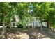 Stunning home featuring a white stucco exterior, black-framed windows and lush landscaping at 410 Glenmont Ct, Atlanta, GA 30350