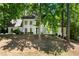 Stunning home featuring a white stucco exterior, black-framed windows and lush landscaping at 410 Glenmont Ct, Atlanta, GA 30350