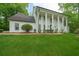 Beautiful front exterior with white columns, black trim windows and a well-maintained lawn at 410 Glenmont Ct, Atlanta, GA 30350