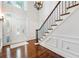 Bright foyer features hardwood floors, staircase, and decorative glass front door at 410 Glenmont Ct, Atlanta, GA 30350