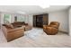 Living room with cozy leather furniture and a large media center with sliding barn doors at 410 Glenmont Ct, Atlanta, GA 30350