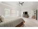 Inviting main bedroom featuring carpet floors, natural light, a ceiling fan, and a comfortable bed at 410 Glenmont Ct, Atlanta, GA 30350