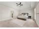 Bright and airy main bedroom with a tray ceiling, plush carpeting, and natural light at 410 Glenmont Ct, Atlanta, GA 30350