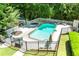 The backyard featuring a pool, lounge chairs, manicured lawn, and privacy fence at 410 Glenmont Ct, Atlanta, GA 30350