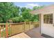 Inviting back deck with decorative sunburst railing and view of the lush, tree-filled backyard and a small gazebo at 701 Rosedale Se Dr, Smyrna, GA 30082
