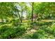 Lush backyard with gazebo, mature trees and greenery, offering a peaceful retreat at 701 Rosedale Se Dr, Smyrna, GA 30082