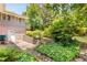 Charming backyard with brick retaining wall, mature landscaping, and patio, offering a serene outdoor space at 701 Rosedale Se Dr, Smyrna, GA 30082