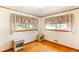 Cozy bedroom featuring hardwood floors, floral curtains, and ample natural light at 701 Rosedale Se Dr, Smyrna, GA 30082
