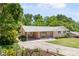 Charming brick home featuring a covered parking area, landscaped front yard, and mature trees at 701 Rosedale Se Dr, Smyrna, GA 30082