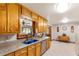Cozy kitchen with wood cabinets, a blue sink, tile floors, and an open layout to the dining area at 701 Rosedale Se Dr, Smyrna, GA 30082