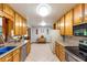 Traditional kitchen with wood cabinets, tile floors, and a view of the adjacent dining area at 701 Rosedale Se Dr, Smyrna, GA 30082