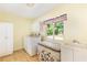 Bright laundry room featuring a window, washer, dryer, cabinets, and a utility sink at 701 Rosedale Se Dr, Smyrna, GA 30082