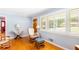 Bright living room featuring hardwood floors, a rocking chair, and natural light from shuttered windows at 701 Rosedale Se Dr, Smyrna, GA 30082