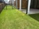 Spacious backyard featuring a lush lawn, complemented by a retaining wall at 816 Dodd S Trl # 172, Buford, GA 30518