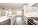 Open kitchen boasts a center island, stainless steel appliances, and white cabinets at 816 Dodd S Trl # 172, Buford, GA 30518