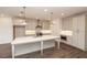 Modern kitchen with stainless appliances, quartz countertops, and custom white cabinets at 816 Dodd S Trl # 172, Buford, GA 30518