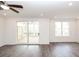 Bright living room with wood flooring and a sliding glass door leading to an outdoor deck at 816 Dodd S Trl # 172, Buford, GA 30518