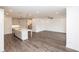 Open floor plan with a kitchen island, gas range, stainless hood, and white cabinets at 816 Dodd S Trl # 172, Buford, GA 30518