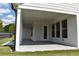 Spacious covered back porch area with concrete flooring, great for outdoor living at 1619 Tielman Way, Snellville, GA 30078