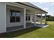 Covered back porch with columns and views of the backyard at 1619 Tielman Way, Snellville, GA 30078