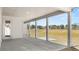 Covered back porch with white support columns and concrete flooring with view of backyard at 1619 Tielman Way, Snellville, GA 30078