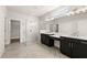 Elegant bathroom with walk-in glass shower, double vanities, neutral walls and floors, and modern fixtures at 1619 Tielman Way, Snellville, GA 30078