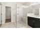 Sleek primary bathroom featuring a modern glass shower and view of the dual sink vanity at 1619 Tielman Way, Snellville, GA 30078