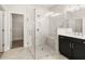 Modern bathroom featuring a walk-in glass shower with a seat, double vanities, and closet on the left at 1619 Tielman Way, Snellville, GA 30078