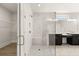 Elegant glass shower in primary bathroom with marble tile and a view of the dual sink vanity at 1619 Tielman Way, Snellville, GA 30078