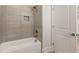 Bathroom features a tiled shower-tub combination with a shower head and faucet at 1619 Tielman Way, Snellville, GA 30078