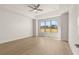 Spacious bedroom featuring a tray ceiling, fan, and a large window at 1619 Tielman Way, Snellville, GA 30078