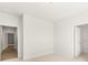 Bright bedroom with carpet, a large closet, and a view into the hallway featuring wood-look floors at 1619 Tielman Way, Snellville, GA 30078