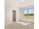 Carpeted bedroom with a large window offering natural light and a spacious closet for ample storage at 1619 Tielman Way, Snellville, GA 30078