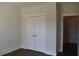 Bedroom with hardwood floors and white closet doors at 1619 Tielman Way, Snellville, GA 30078