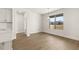 Bright dining area featuring wood floors, large window and modern lighting at 1619 Tielman Way, Snellville, GA 30078