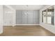Dining area with decorative wall, modern chandelier, hardwood floors, and great natural light at 1619 Tielman Way, Snellville, GA 30078