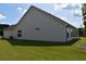 Beautiful side view of home with well-maintained lawn and covered patio at 1619 Tielman Way, Snellville, GA 30078