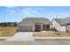 Charming one-story home with a gray brick facade, two-car garage, and beautifully landscaped front yard at 1619 Tielman Way, Snellville, GA 30078