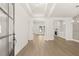 Spacious entryway featuring wood floors, white walls, and an open floor plan with views into the living spaces at 1619 Tielman Way, Snellville, GA 30078