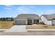 Charming single-story home with gray brick, gray shutters, and a well-manicured lawn at 1619 Tielman Way, Snellville, GA 30078