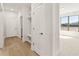 Bright hallway featuring a convenient built-in bench and ample storage with a view into the sunlit bedroom at 1619 Tielman Way, Snellville, GA 30078