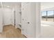 Bright hallway featuring wood floors, white walls and trim, and a convenient built-in storage nook at 1619 Tielman Way, Snellville, GA 30078