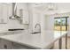 Bright kitchen featuring a large quartz island, stainless steel appliances, and a subway tile backsplash at 1619 Tielman Way, Snellville, GA 30078