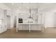 Open kitchen with large island, stainless appliances, white cabinets, and pendant lighting at 1619 Tielman Way, Snellville, GA 30078