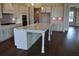 Spacious kitchen featuring a large island with a sink, and stylish cabinetry at 1619 Tielman Way, Snellville, GA 30078